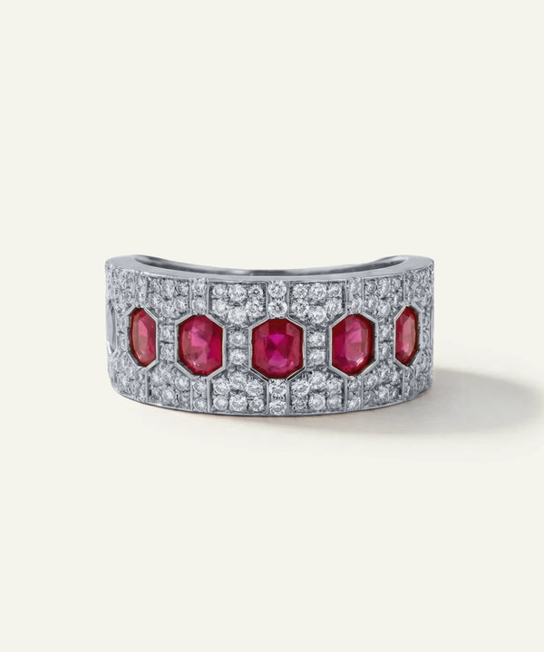 Gold bracelet with red gemstones and diamonds on a white background