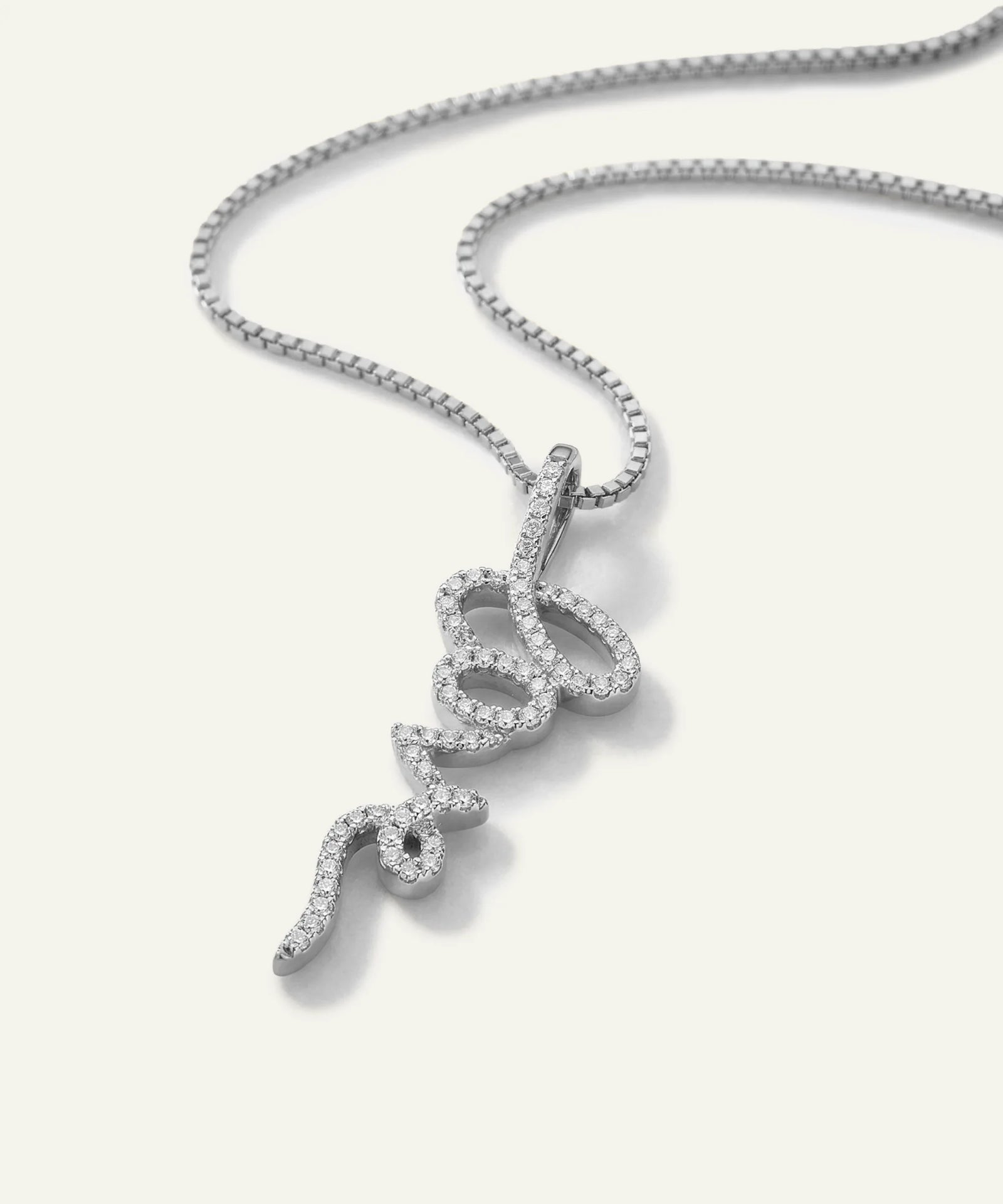 Silver necklace with a unique pendant on a light gray background