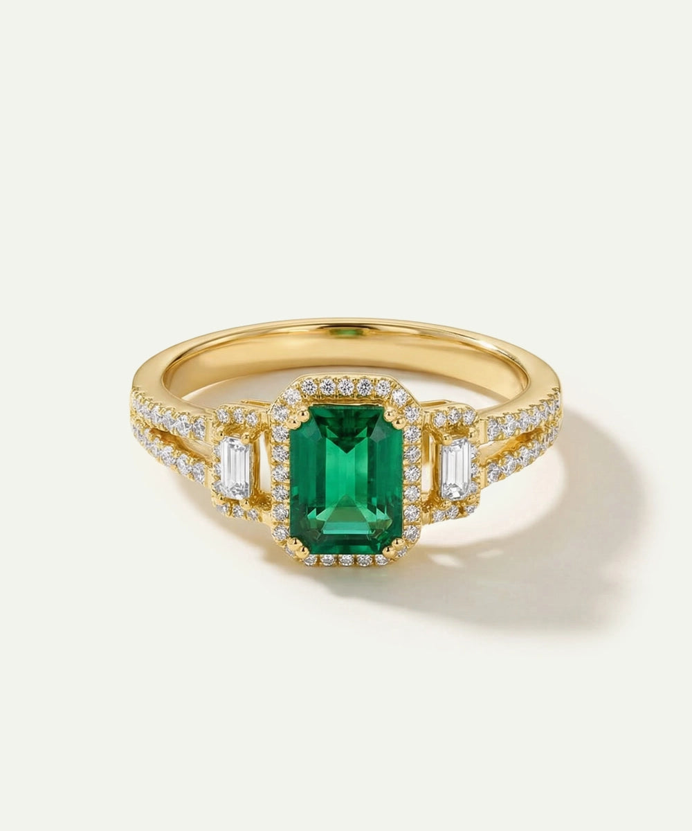 Gold ring with a green gemstone on a light background