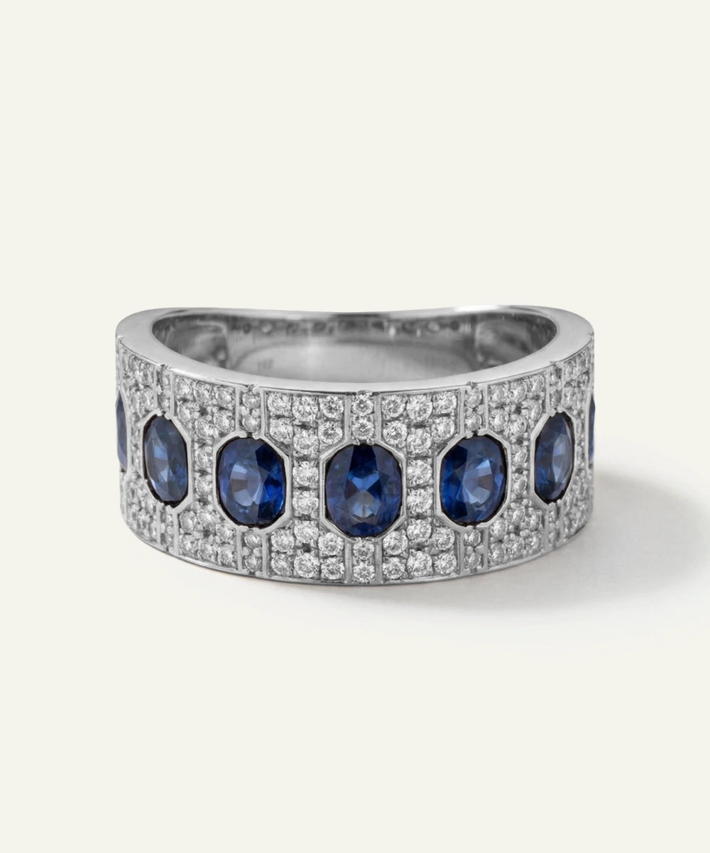 Silver ring with blue gemstones on a white background