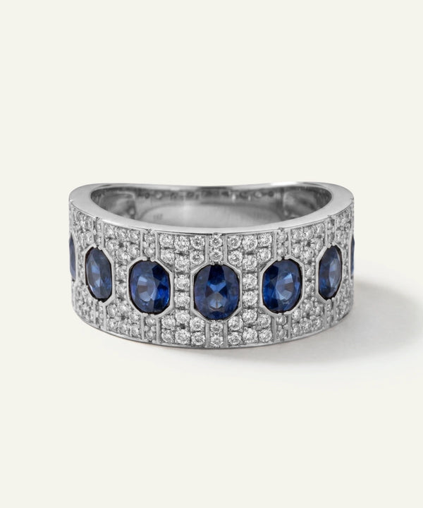 Silver ring with blue gemstones on a white background