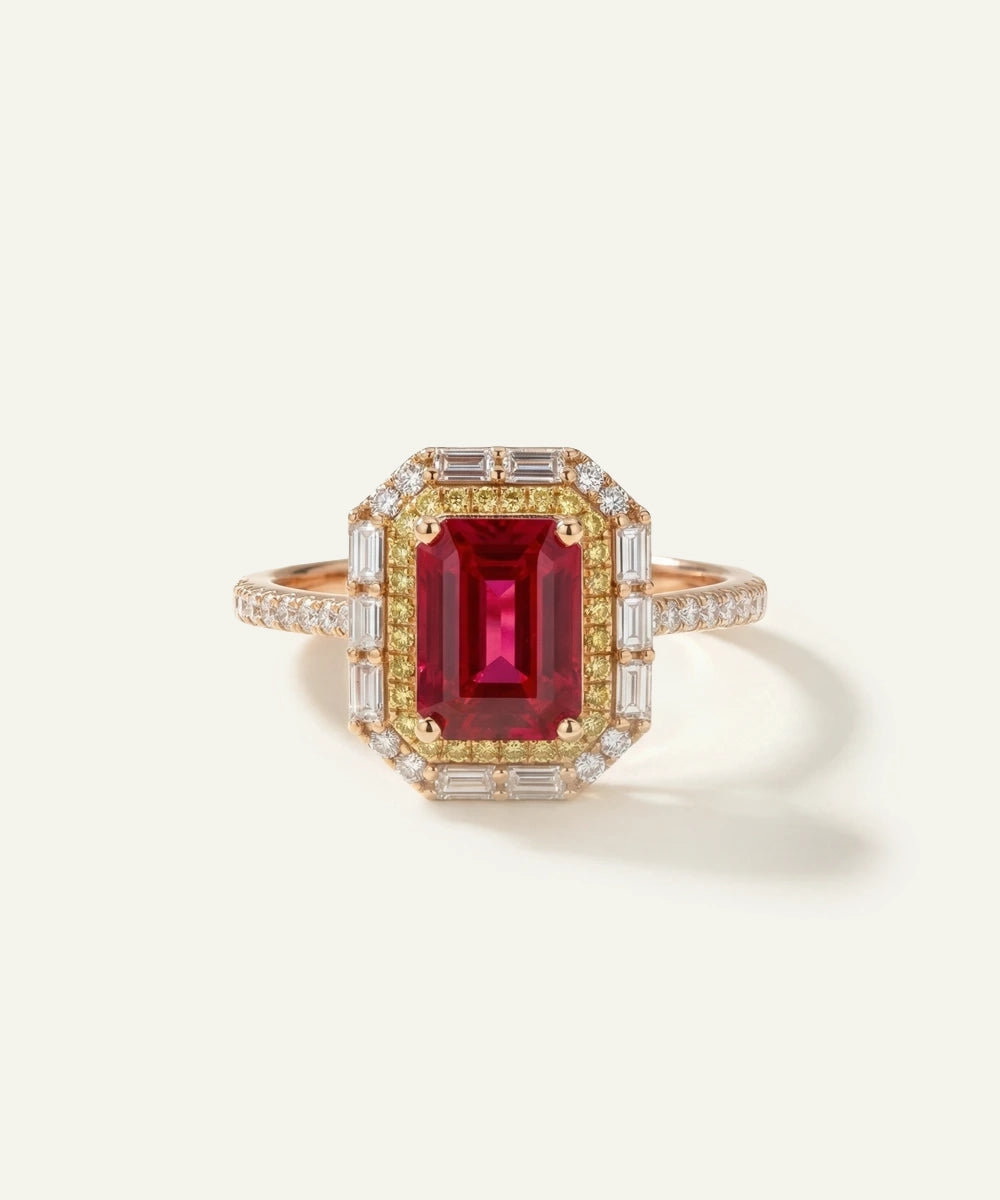 Elegant ring with a red gemstone and gold band on a light background