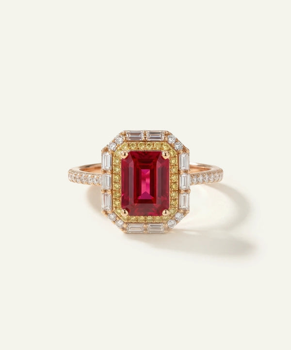 Elegant ring with a red gemstone and gold band on a light background