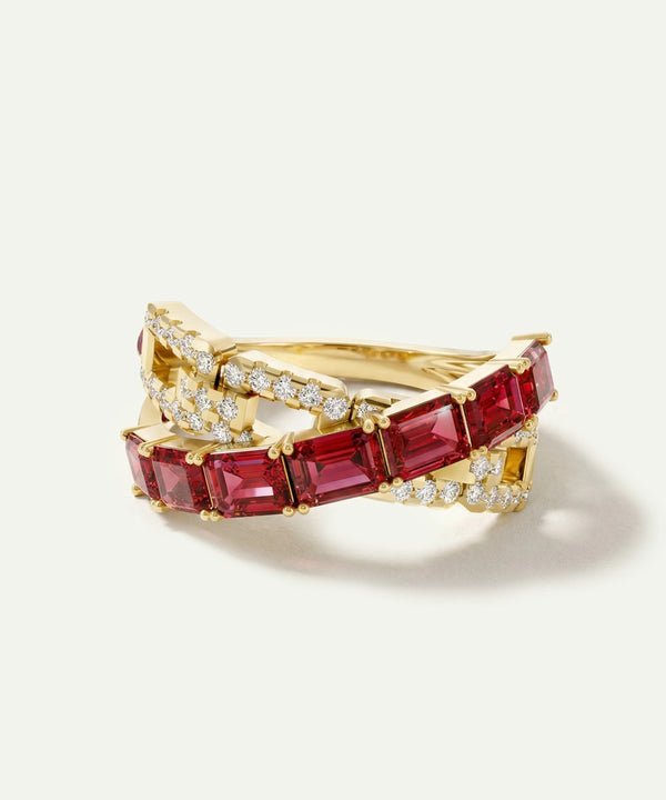Gold ring with red gemstones on a white background