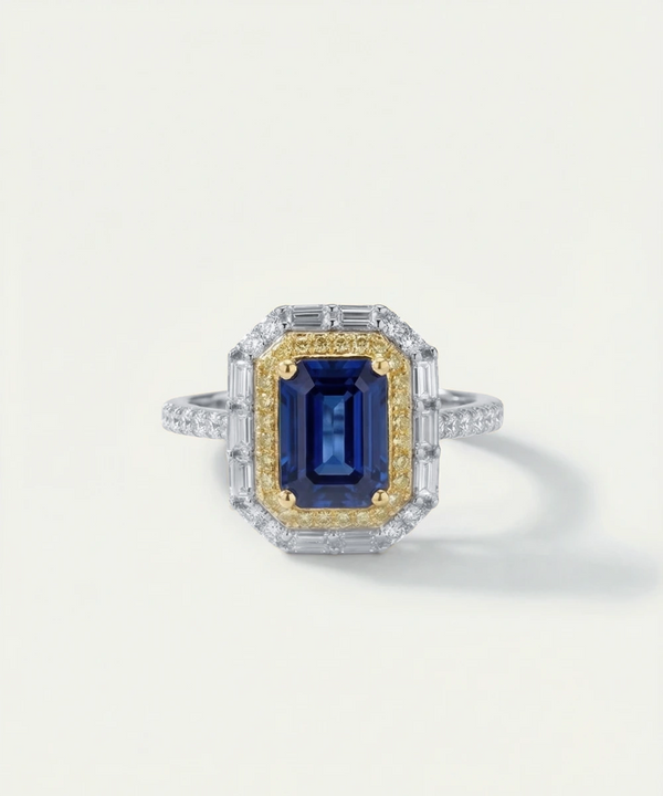 Ring with a blue gemstone and gold accents on a white background