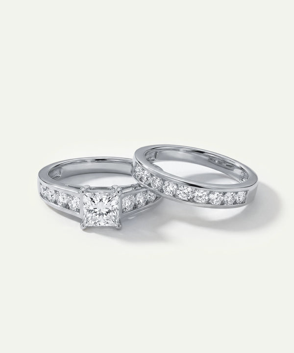 White gold princess-cut diamond engagement ring and matching channel-set wedding band set.
