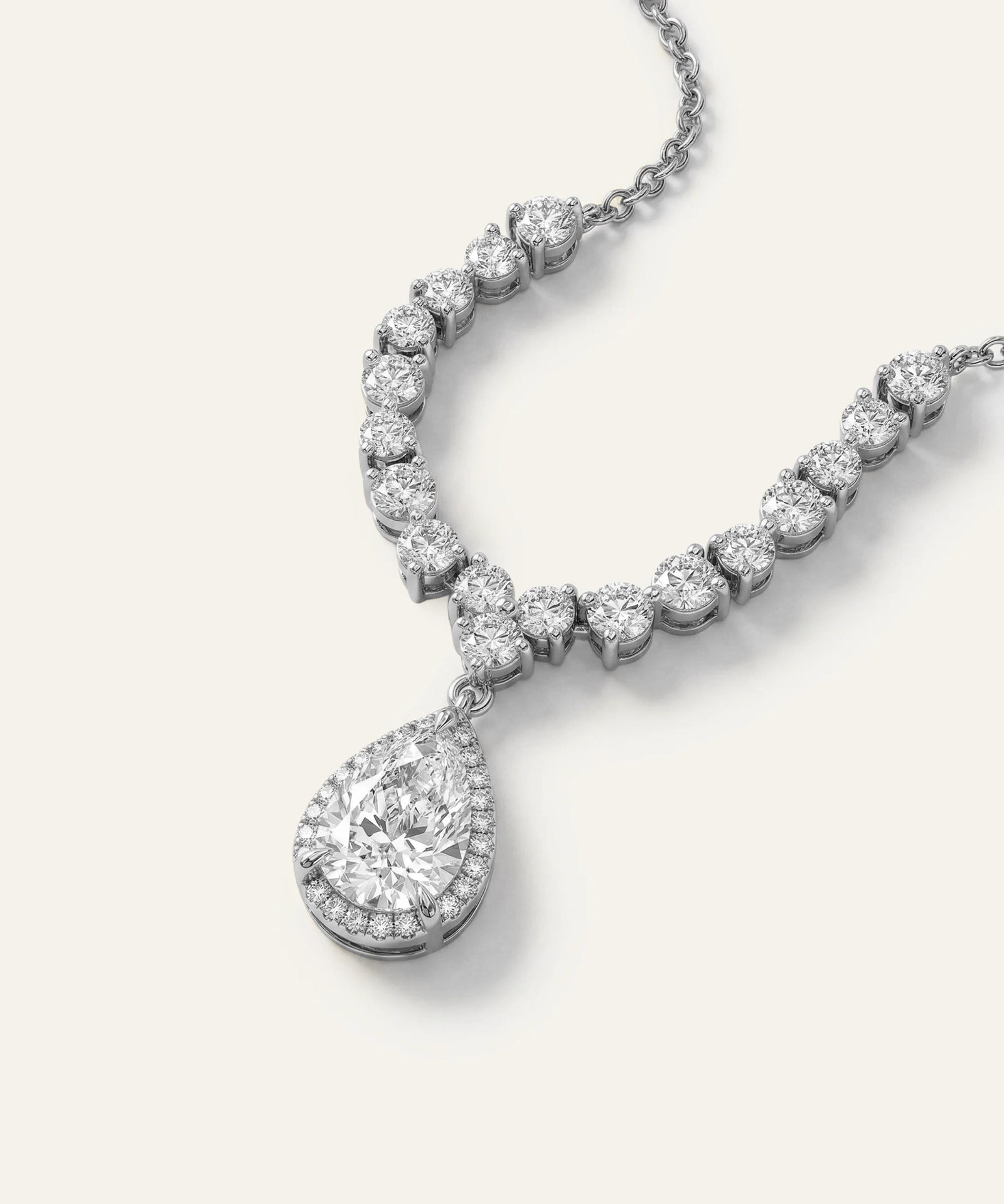 Diamond necklace with a teardrop pendant on a white background