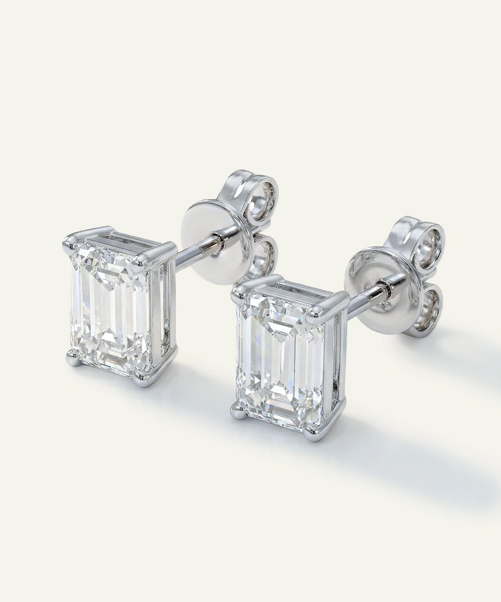 Pair of diamond stud earrings on a white background