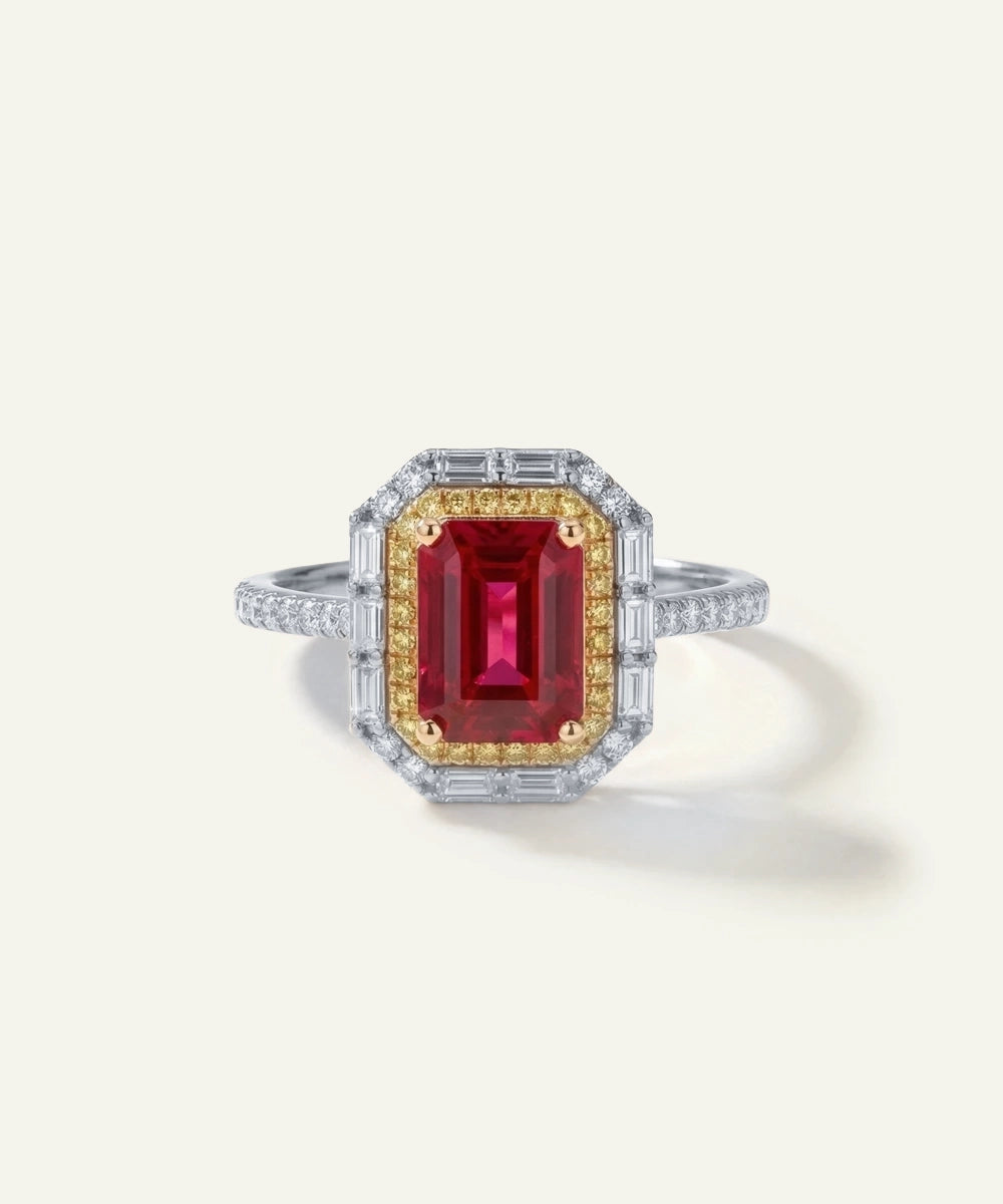 Ring with a red gemstone and gold accents on a white background