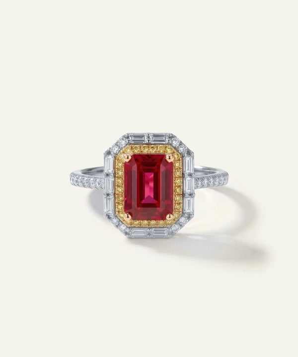Ring with a red gemstone and gold accents on a white background