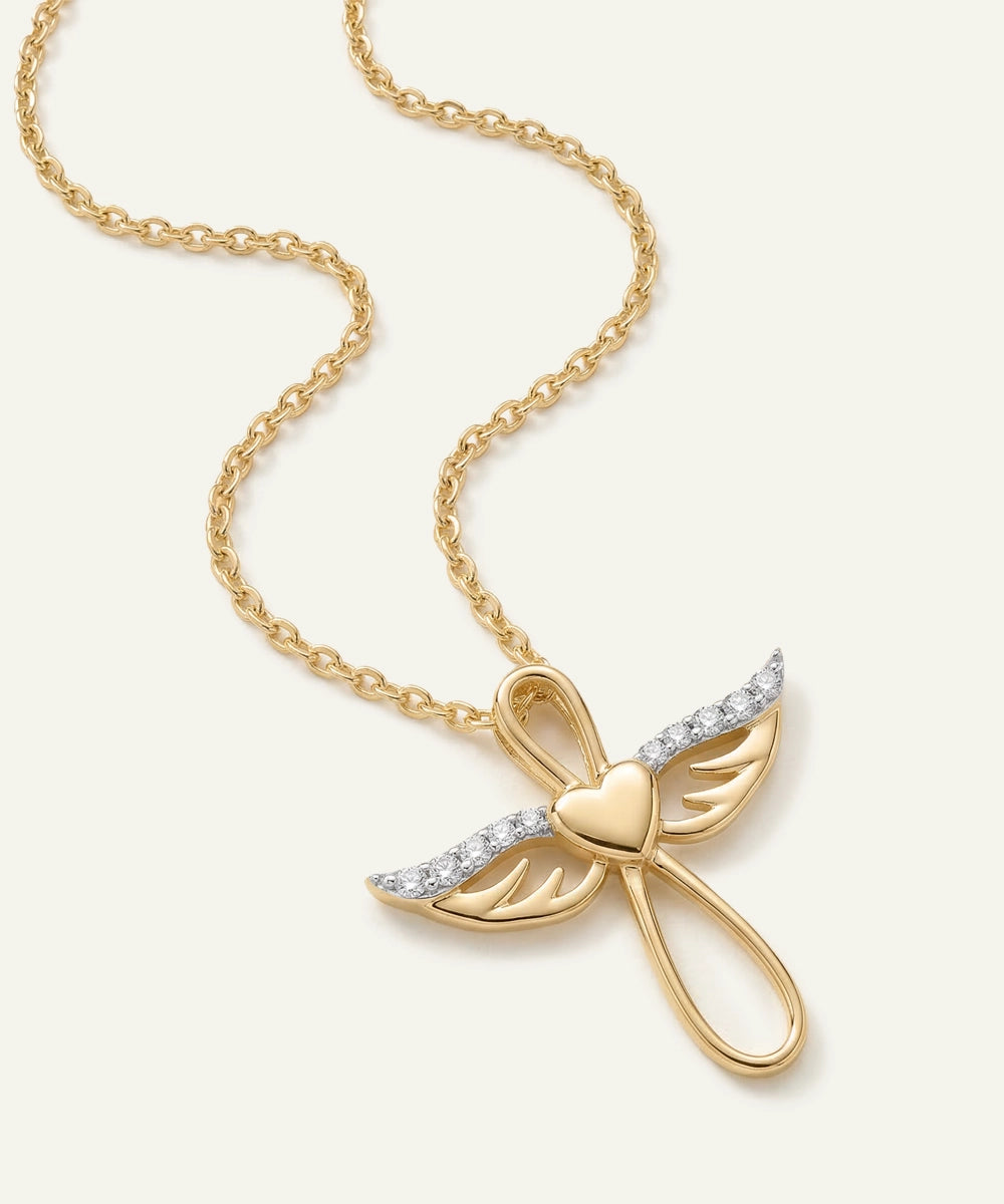 Gold butterfly pendant necklace on a white background