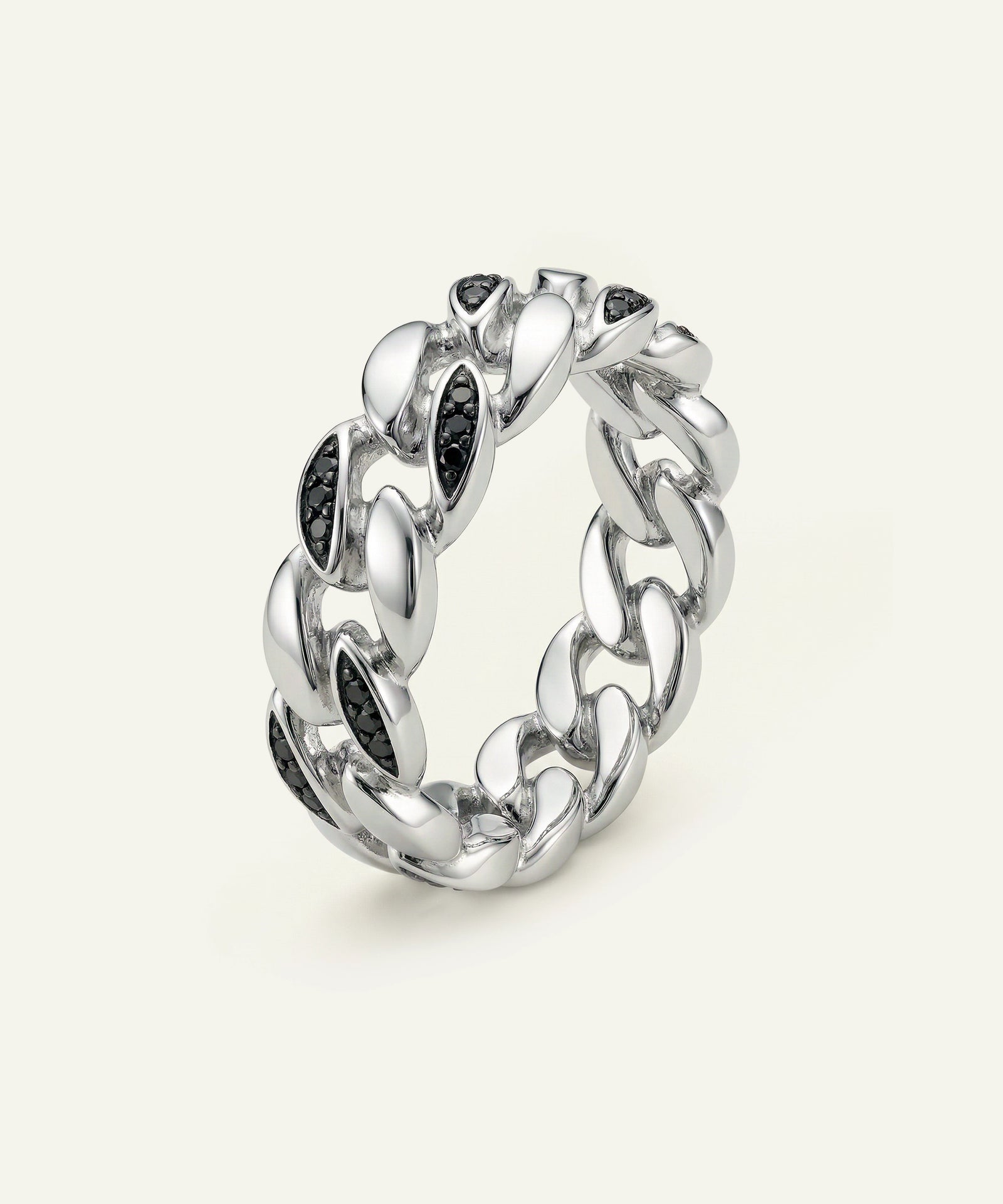 Silver chain-link ring with black stones on a white background