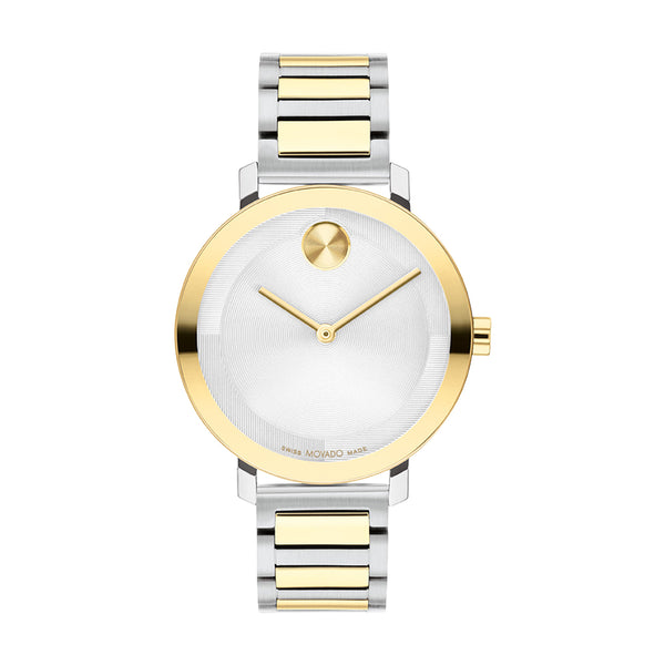 Two-tone gold and silver watch with white face on a white background