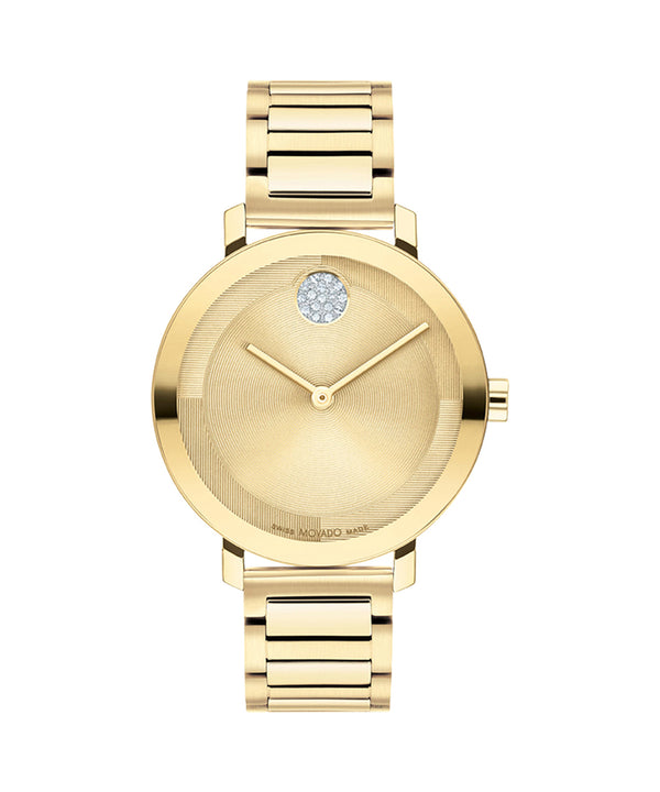 Gold watch with a diamond on the face against a white background
