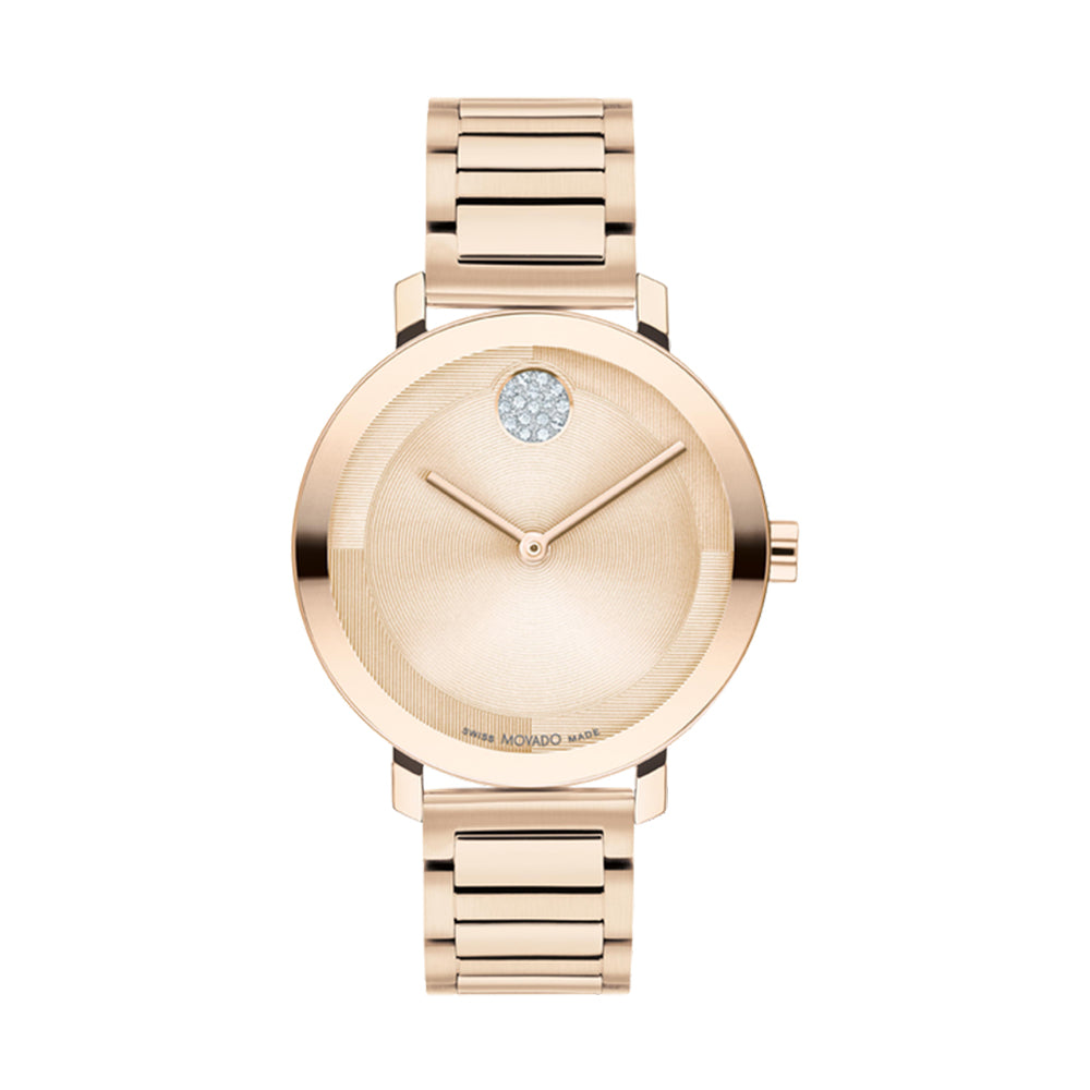Rose gold watch with a gemstone on the dial against a white background