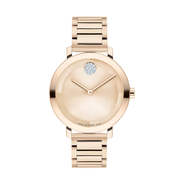 Rose gold watch with a gemstone on the dial against a white background