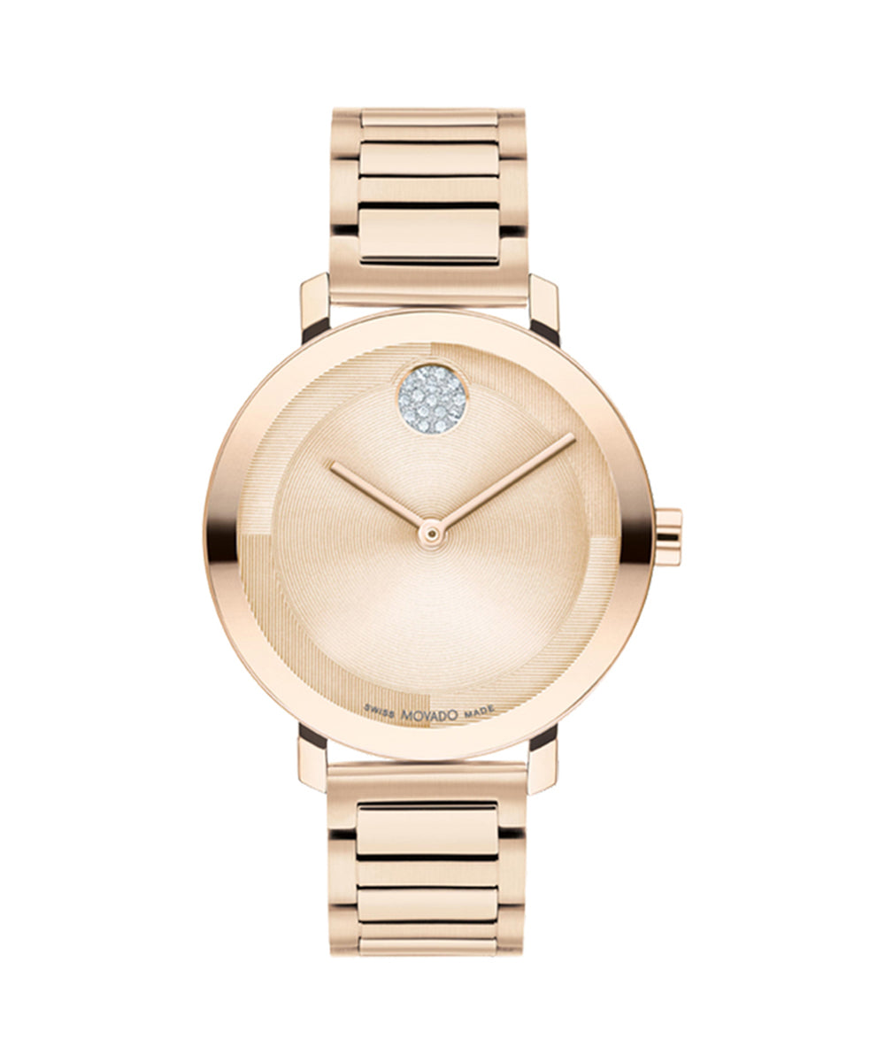 Rose gold watch with a diamond on the face against a white background