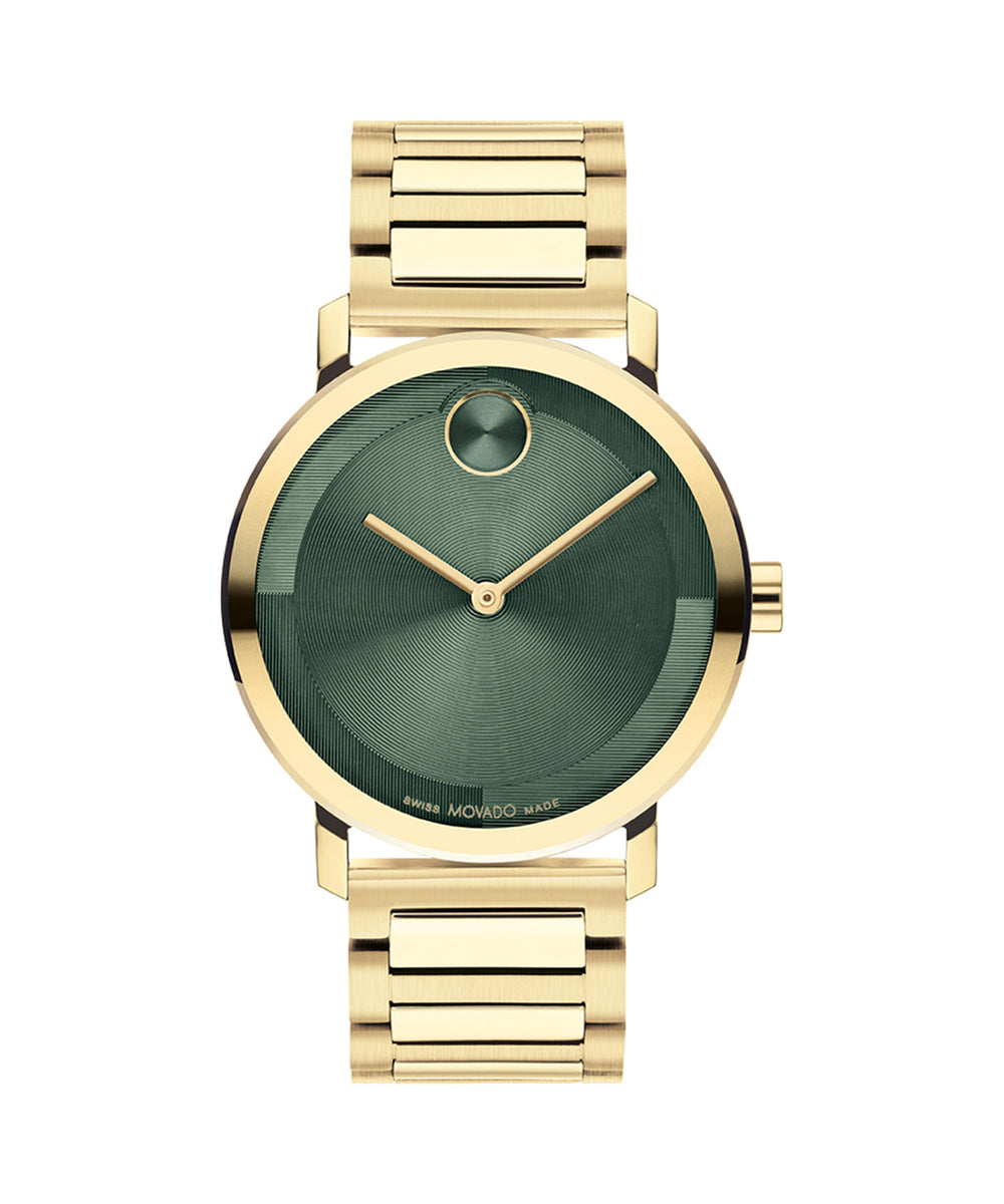 Gold watch with green face on a white background