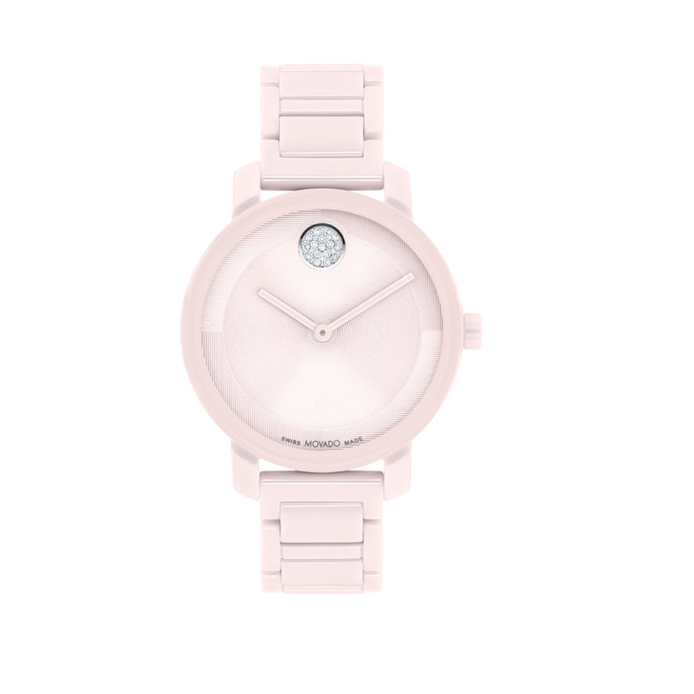 Pink watch with a diamond on the face against a white background