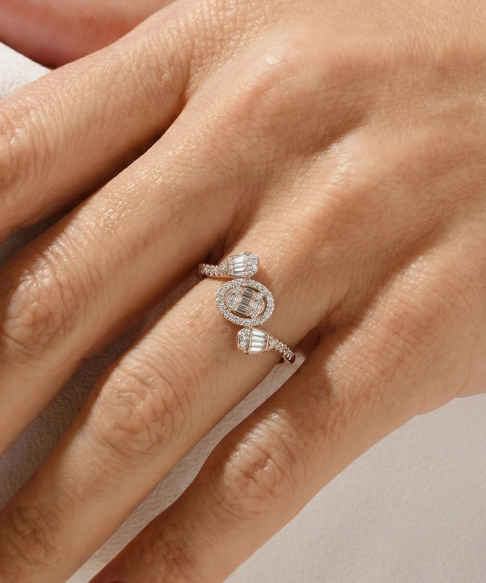 Close-up of a hand wearing a diamond ring on a neutral background