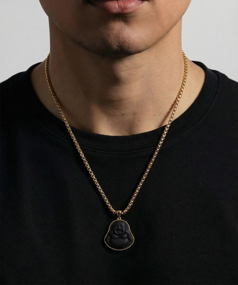 Men's gold chain necklace with a black carved Buddha pendant.