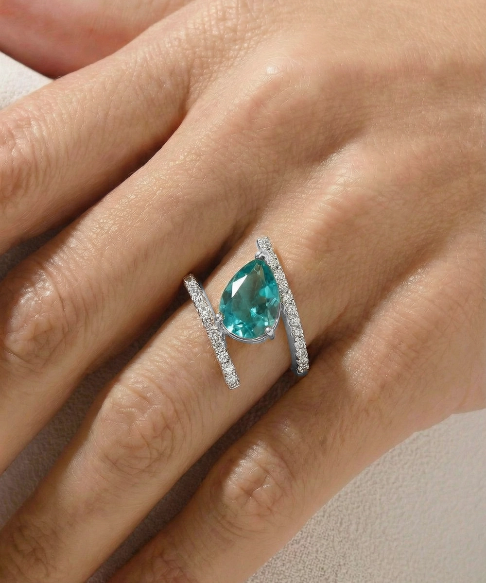 Ring with a pear-shaped blue gemstone on a hand