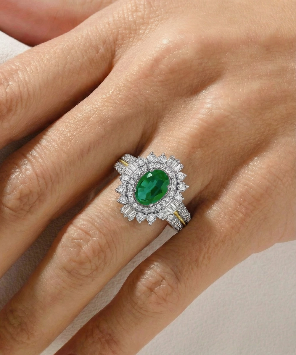 Ring with a green gemstone and diamond accents on a hand against a neutral background