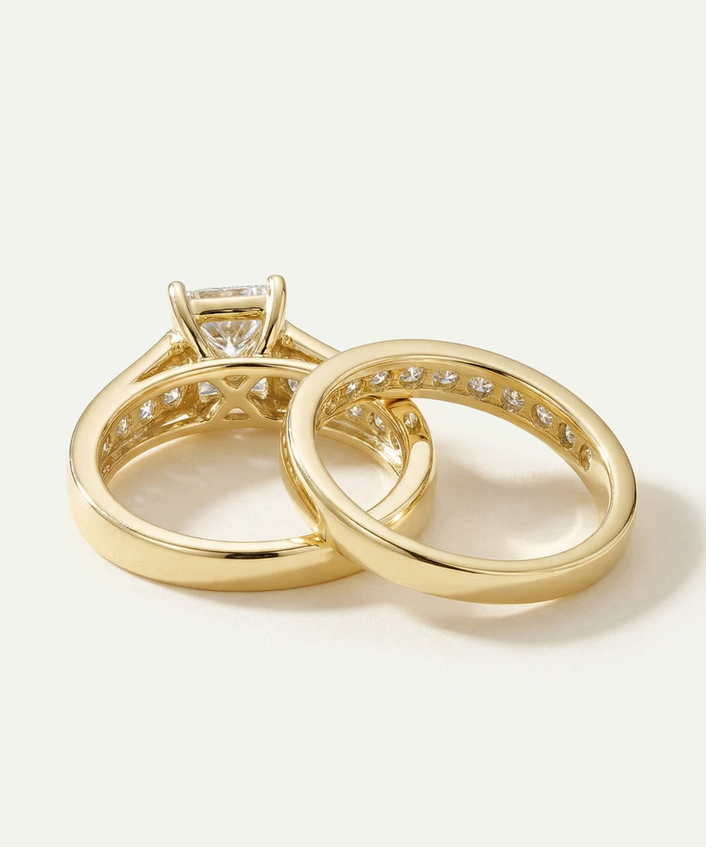 Two gold rings with diamond accents on a light background