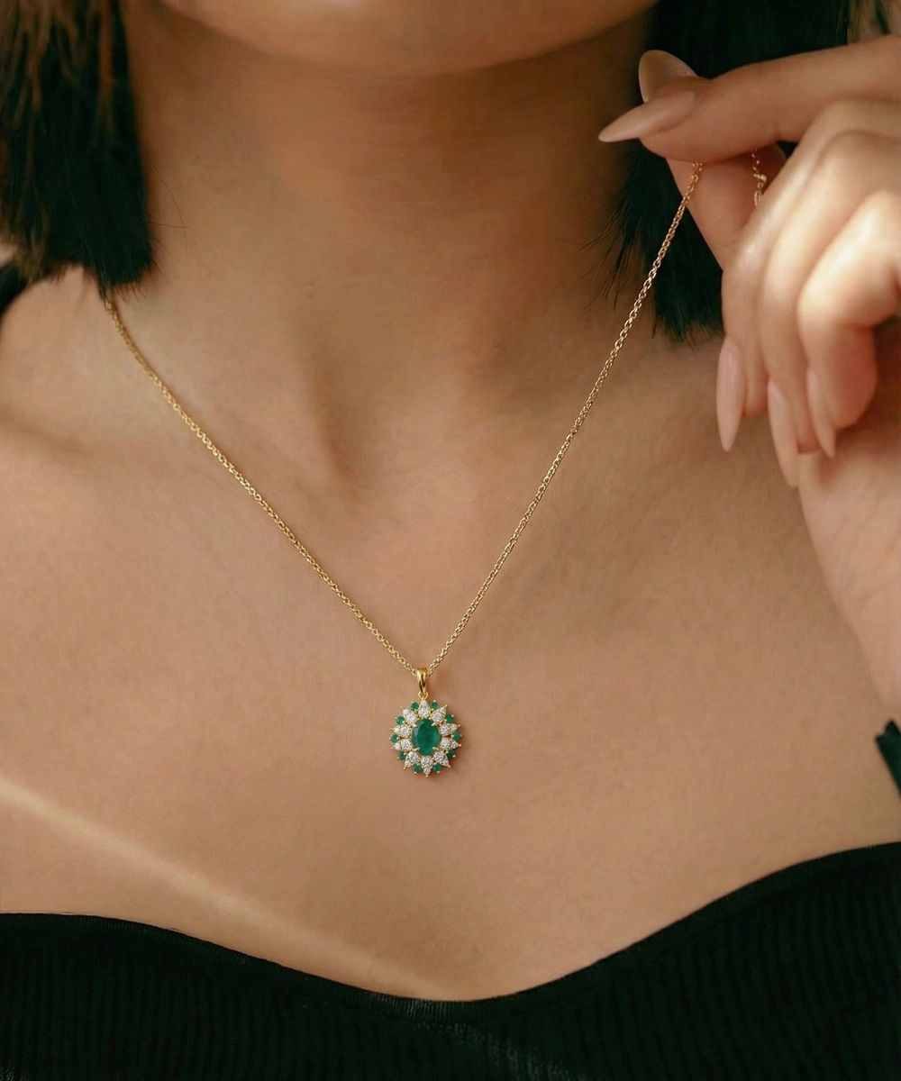 Gold necklace with a green gemstone pendant worn by a person
