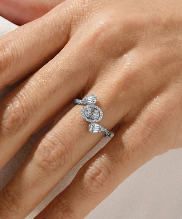 Silver ring with a diamond on a hand against a neutral background