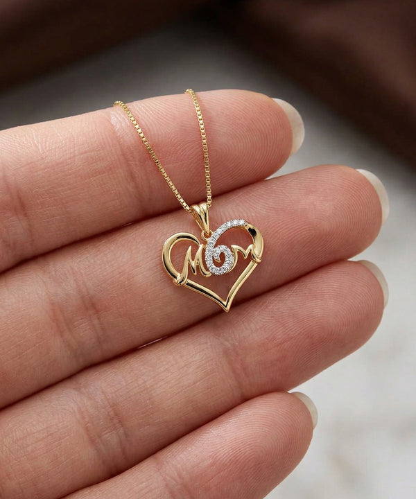 Gold necklace with a heart-shaped pendant on a hand