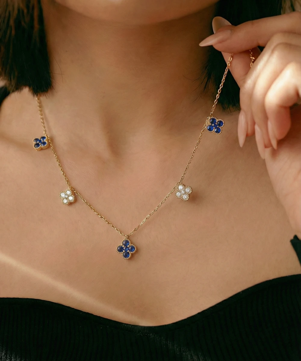 Necklace with floral pendants being adjusted on a person's neck