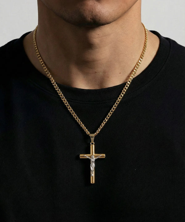 Gold chain necklace with a cross pendant on a black shirt against a gray background