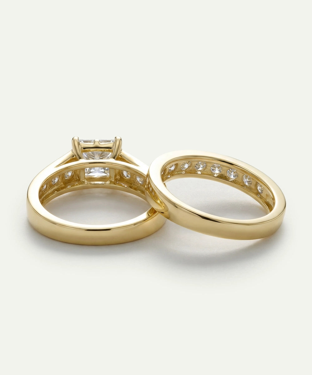 Two gold rings with diamond accents on a light gray background