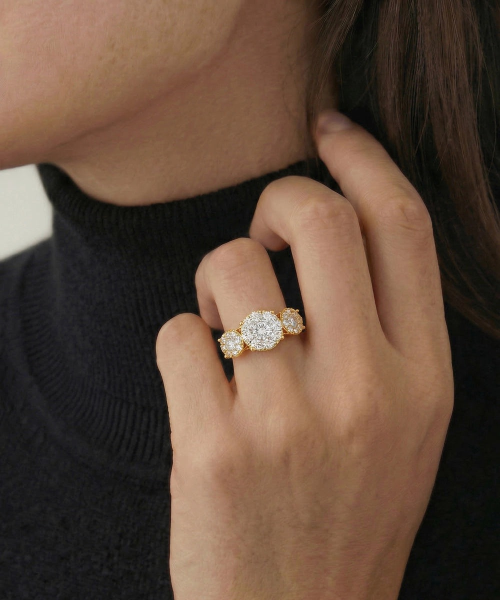 Close-up of a hand wearing a diamond ring with a blurred background