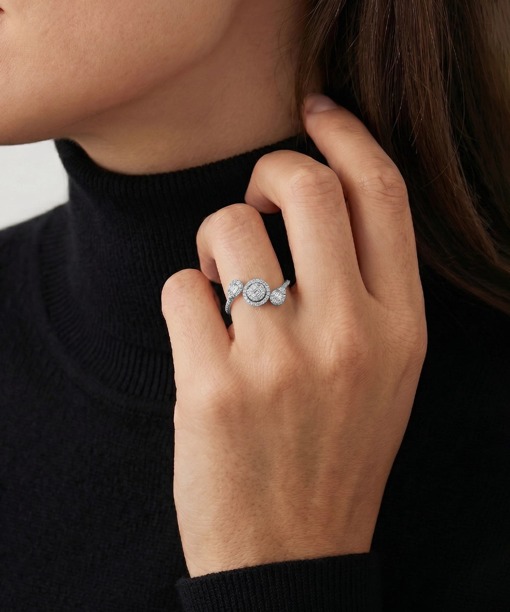 Close-up of a hand wearing a ring with a black background