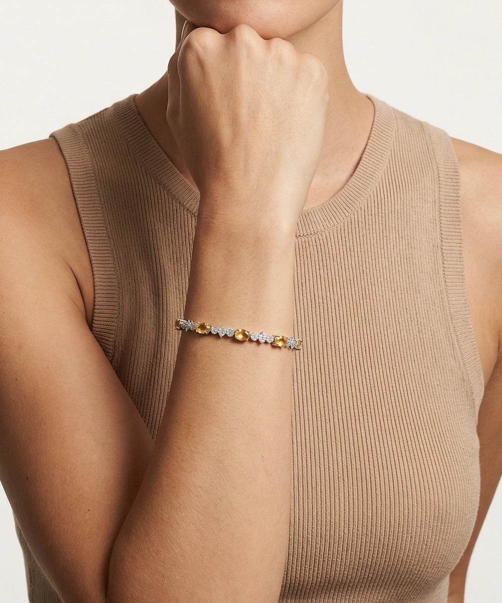 Person wearing a beaded bracelet on a plain background