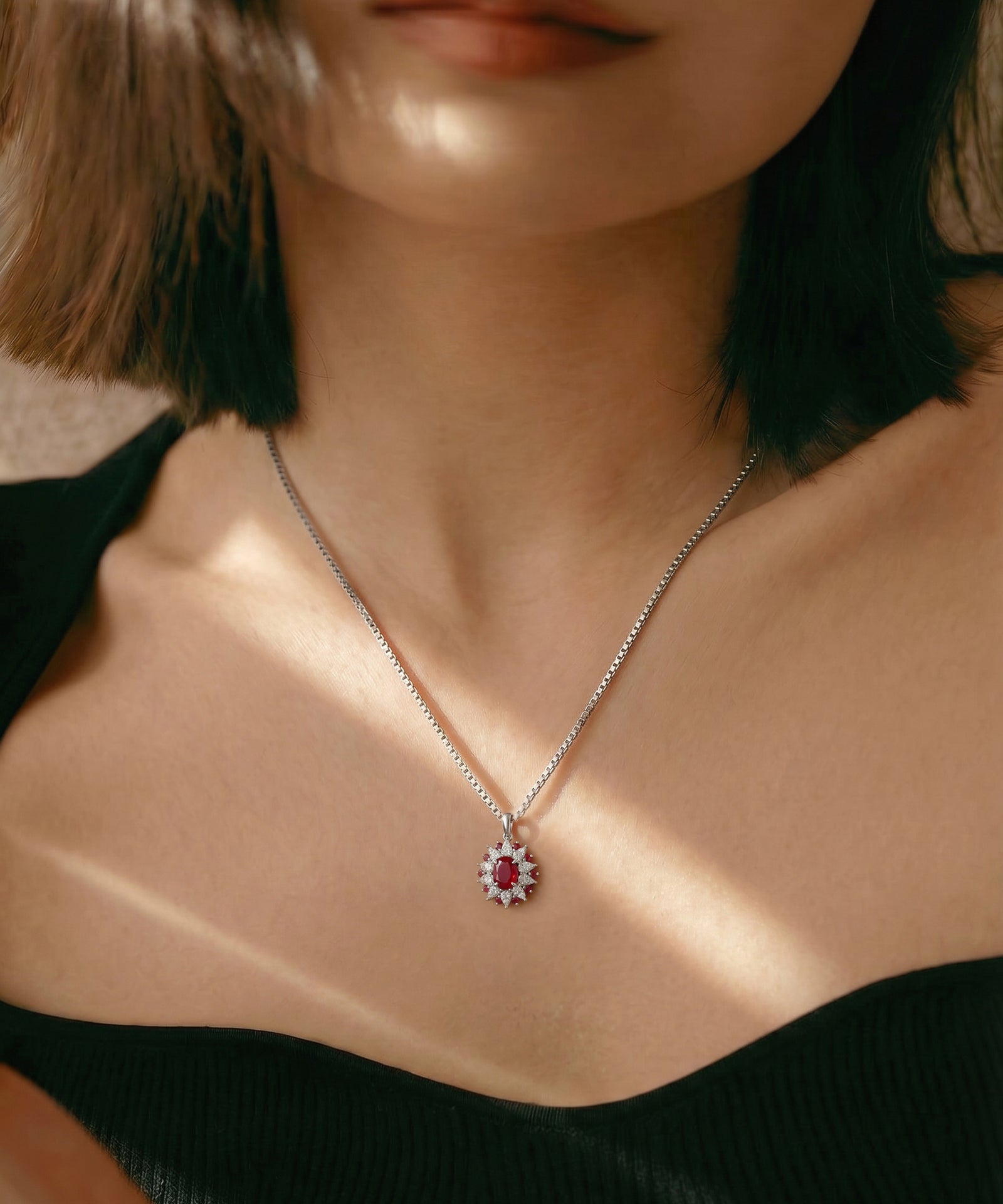 Necklace with a pendant worn by a person, focusing on the jewelry.
