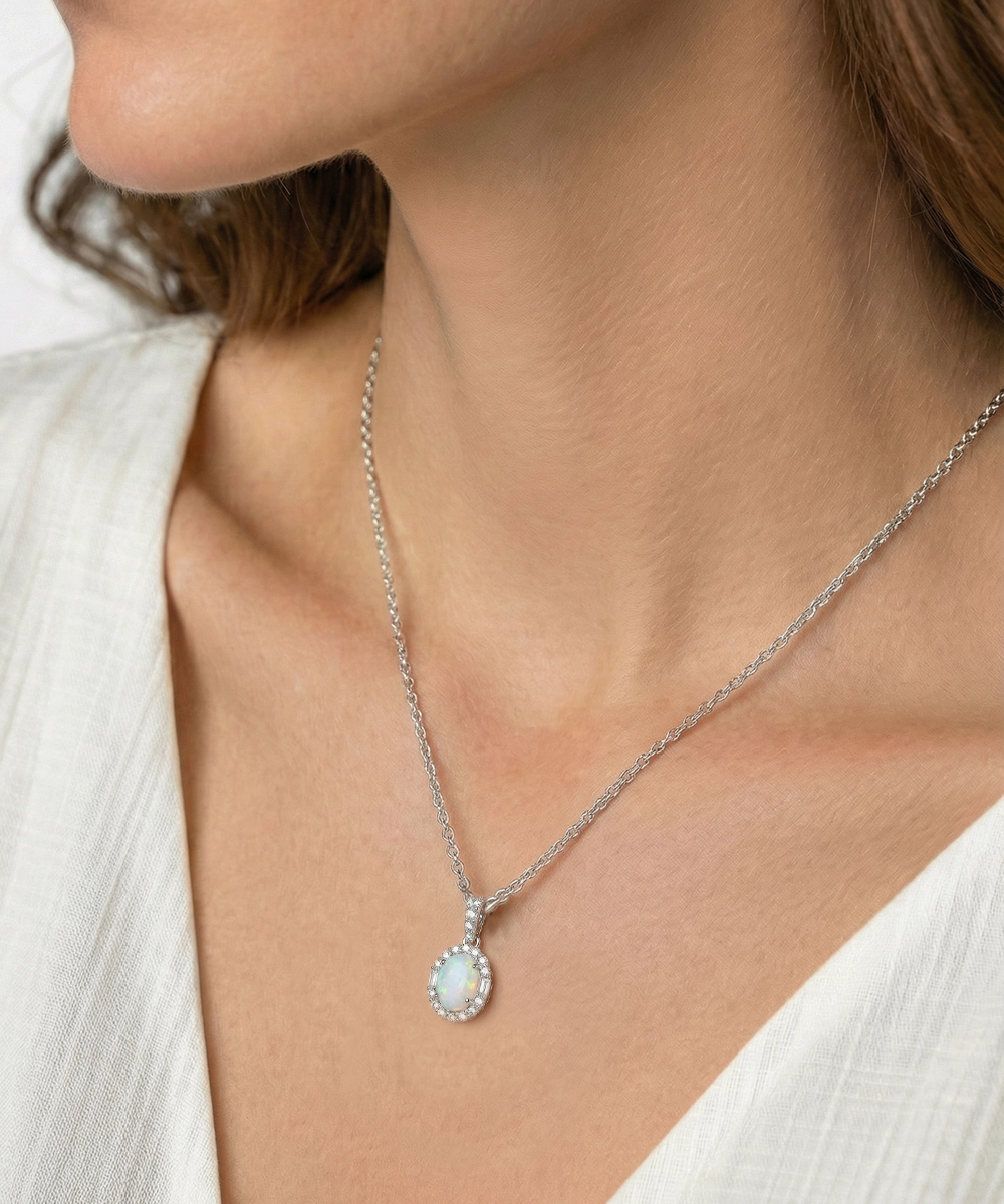 Necklace with a pendant worn by a person in a white outfit