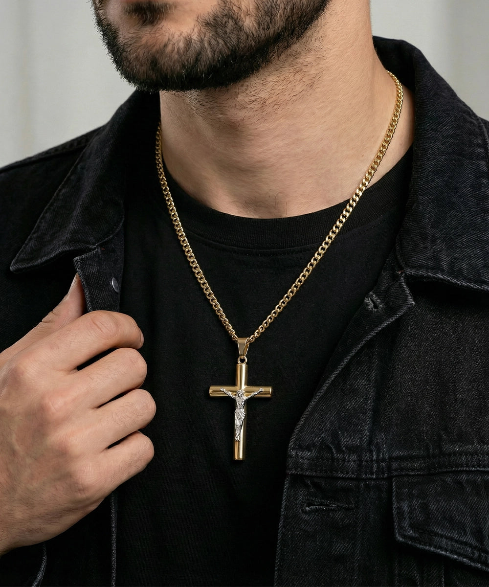 Man wearing a gold chain with a cross pendant on a black shirt.