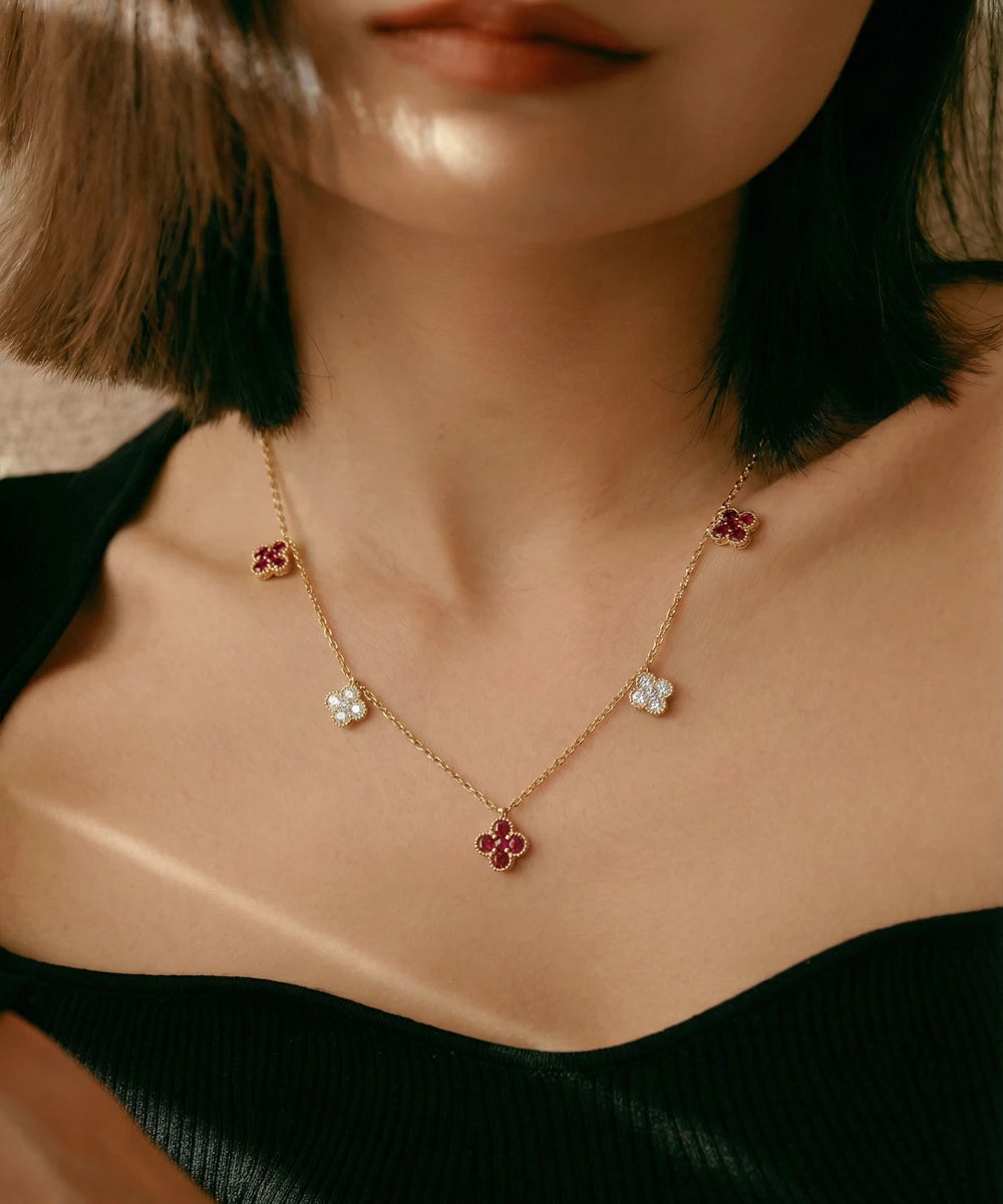 Necklace with floral pendants worn by a person