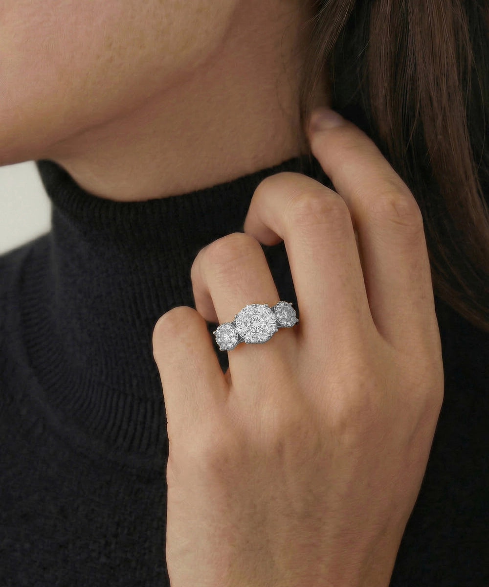 Close-up of a hand wearing a diamond ring with a blurred background