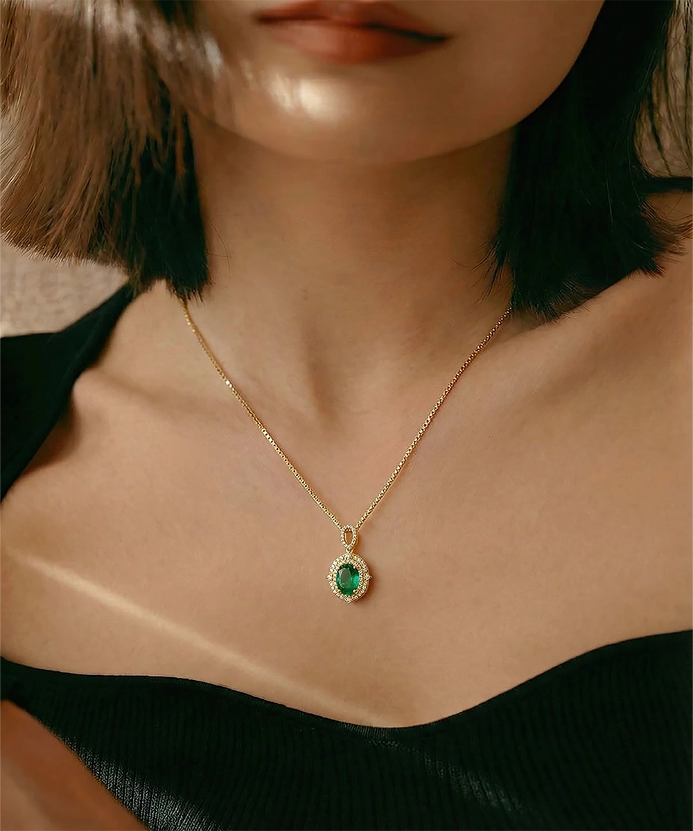 Necklace with a green gemstone pendant worn by a person