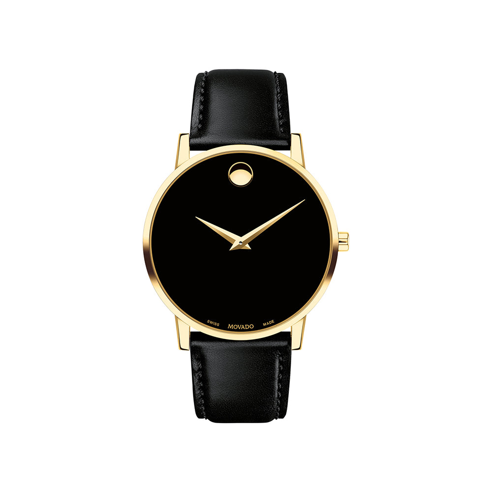Black watch with gold bezel and black leather strap on a white background
