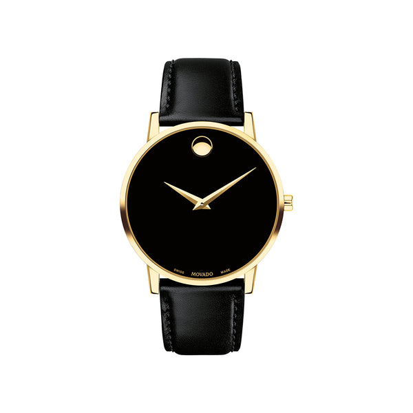 Black watch with gold bezel and black leather strap on a white background