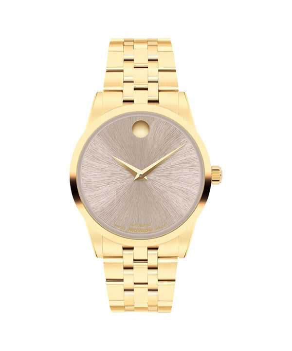 Gold wristwatch with a detailed face on a white background