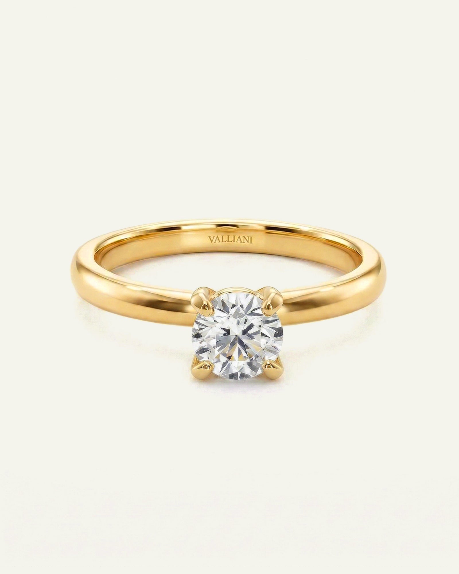 Gold ring with a diamond on a white background