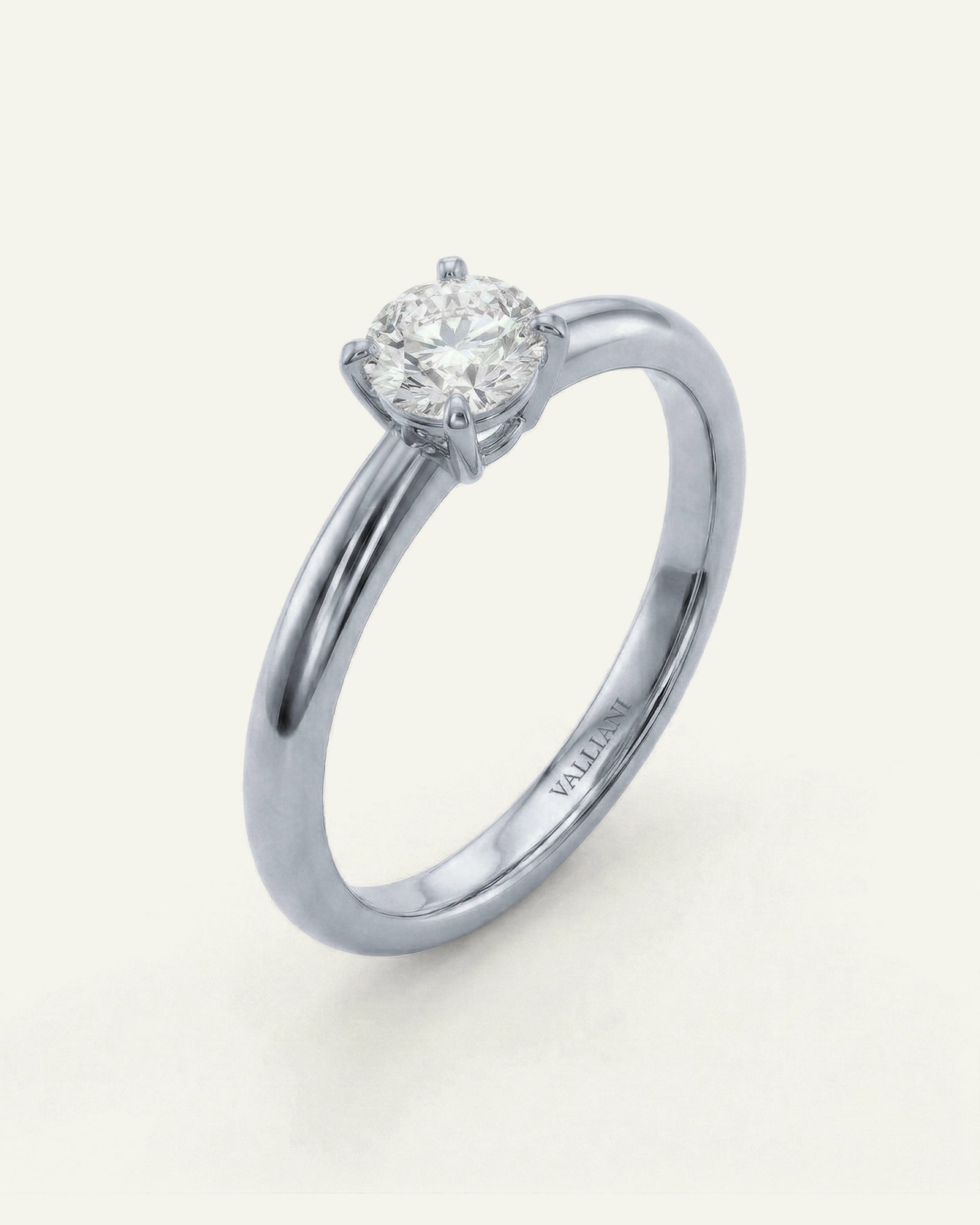 Diamond ring with a white gold band on a light gray background