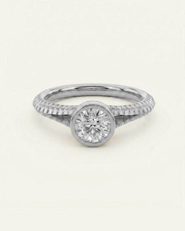 Silver ring with a diamond on a light gray background