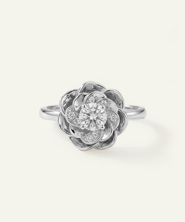 Silver ring with a floral design on a white background